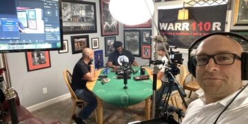 Professional podcast recording session for "Those AshHoles" featuring hosts at a green round table with a "WARRIOR" banner in the background.