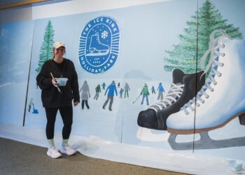 A woman painting for the Holliday Ice Rink
