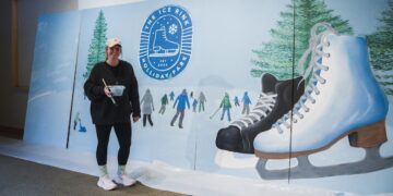 A woman painting for the Holliday Ice Rink