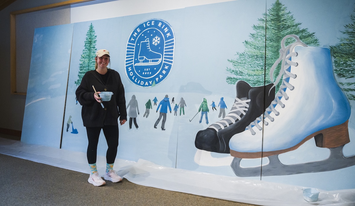 A woman painting for the Holliday Ice Rink