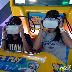 Two children experiencing the immersive SpongeBob VR Bubble Coaster at an indoor arcade.