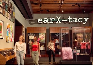 Customers looking at merchandise at ear X - Tacy