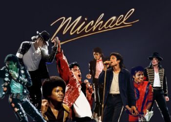 A digital collage featuring multiple depictions of pop star Michael Jackson from different eras of his career. The background is a solid dark gray. At the top center, the word "Michael" is written in a gold, cursive, handwritten font style. The figures of Michael Jackson are arranged across the frame in various iconic outfits and performance poses, capturing his artistic evolution from his youth into his mature solo career.