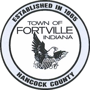 A black-and-white circular official seal for the Town of Fortville, Indiana. The top arc of the outer border reads "ESTABLISHED IN 1865" and the bottom arc reads "HANCOCK COUNTY" in bold uppercase letters. The center features the text "TOWN OF FORTVILLE INDIANA" stacked above an illustration of an American bald eagle with open wings, holding a patriotic shield with stripes in its talons.